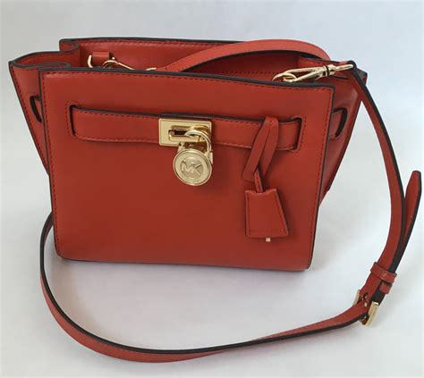 michael kors crossbody orange straps and orange side pouch|Michael Kors purses orange.